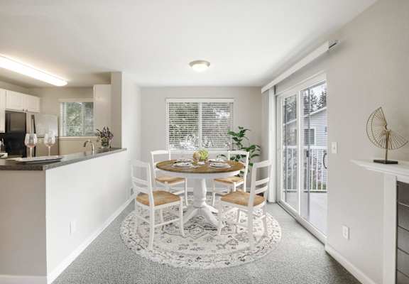 an open kitchen and dining room with a table and chairs