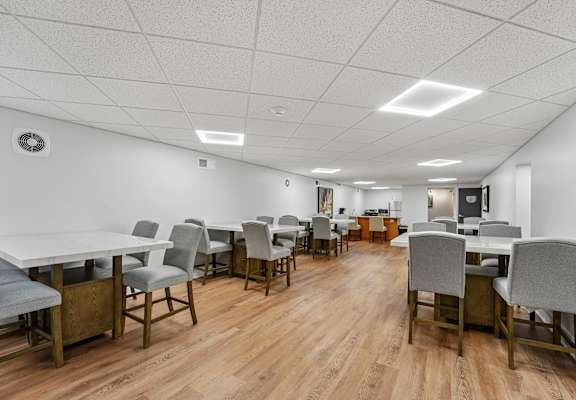 A conference room with a long table and chairs.