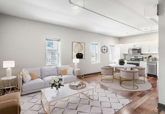 a living room with a grey couch and a white coffee table