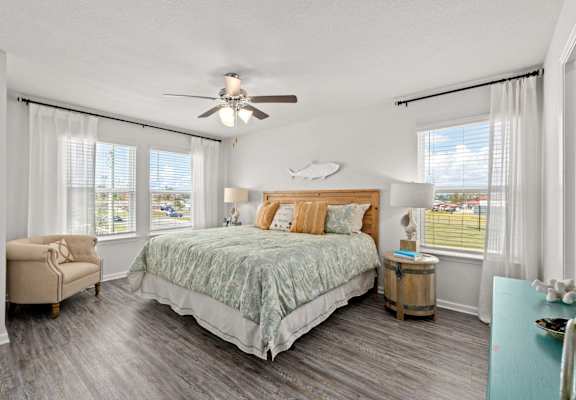 a bedroom with a bed and a ceiling fan