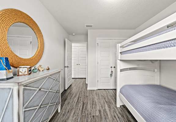 a bedroom with bunk beds and a mirror