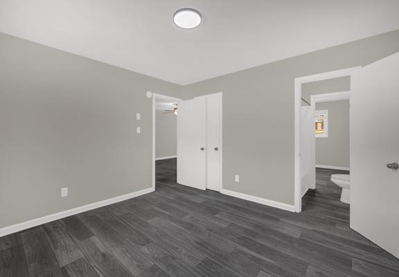 A room with a grey floor and white walls.