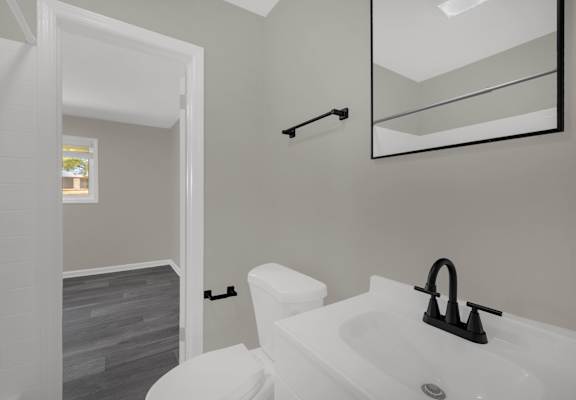 A white bathroom with a toilet and sink.