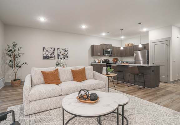 A modern living room with a white couch and a coffee table.