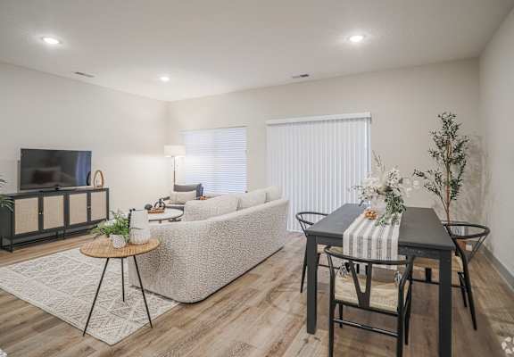 A living room with a sofa, a coffee table, and a television.