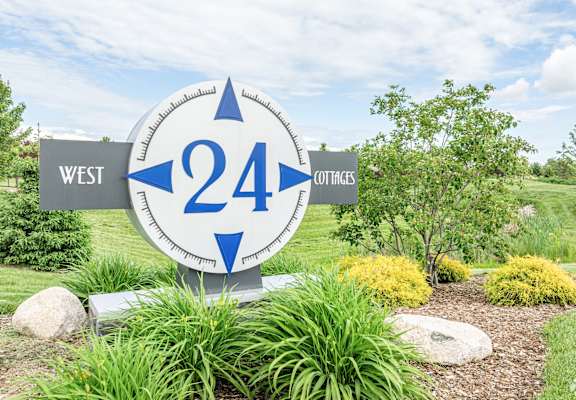 A sign with the number 24 and the word West on it.
