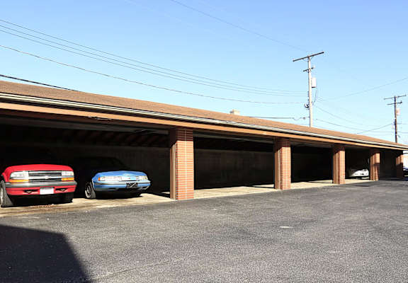 Two cars are parked in a garage.