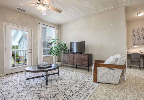 A living room with a flat screen TV and a couch.