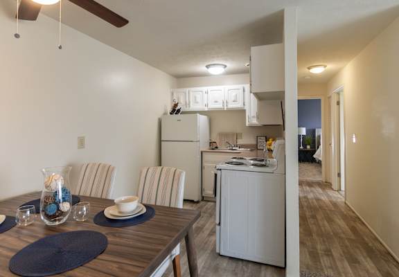Open dining space and kitchen with breakfast bar in a Lisa Ridge apartment home