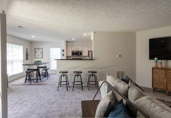 This is a photo of the kitchen and dining room from the living room  of the 1100 square foot 2 bedroom Kettering floor plan at Washington Park Apartments in Centerville, OH.