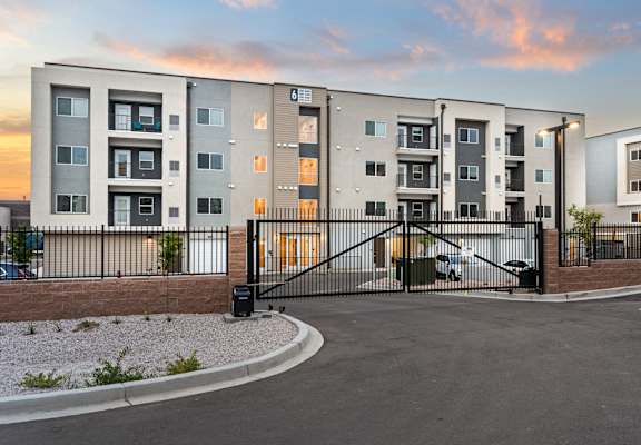 A modern apartment complex with a gated entrance.