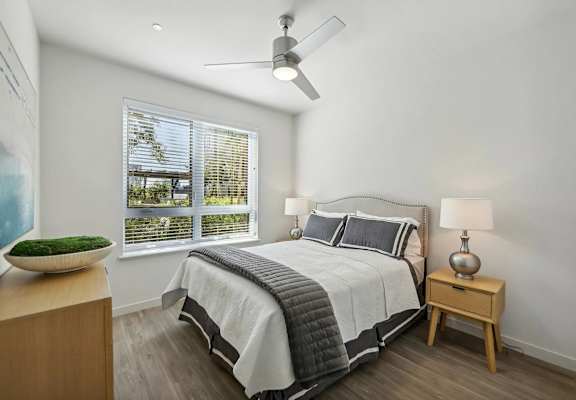 Bedroom with a ceiling fan at Bayview Apartments, Emeryville, 94608