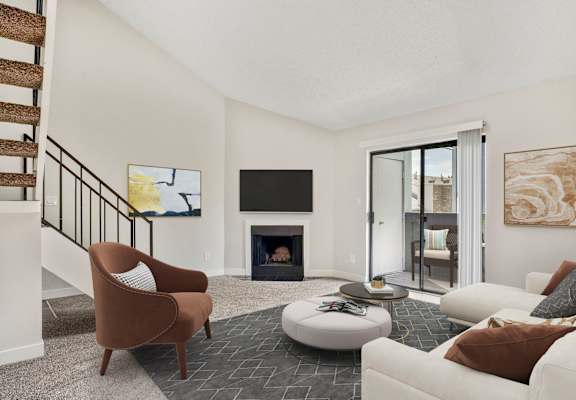 A living room with a fireplace and a television.