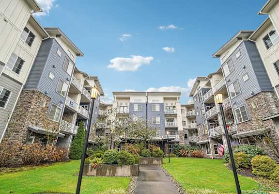 A sunny day at a residential complex with a clear blue sky.