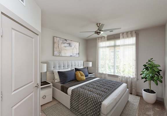 an open bedroom with a bed and a ceiling fan