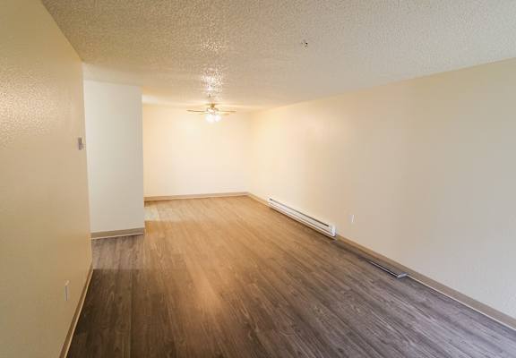 A room with wooden flooring and a ceiling fan.