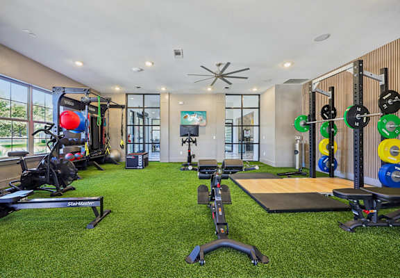 A well-equipped home gym with a variety of exercise equipment. at Vine + Vail Townhomes and Apartments, Texas, 76051