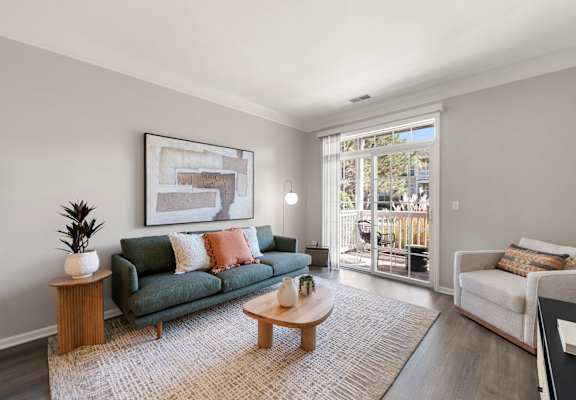 A living room with a green couch and a coffee table.