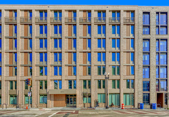 A large building with a brown facade and blue windows.