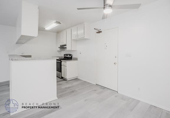 A kitchen area with a stove, oven, and cabinets.