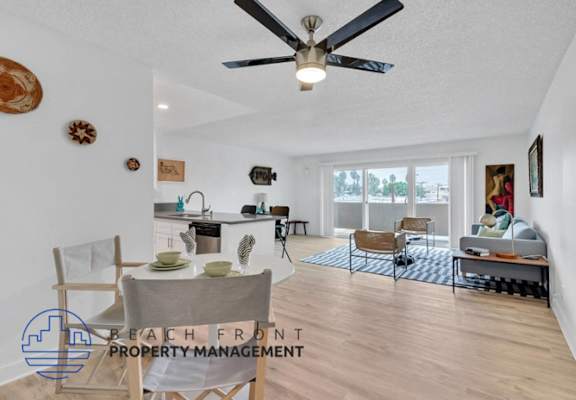 a living room with a ceiling fan and a dining room and a kitchen