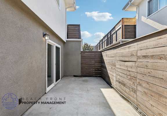 A modern outdoor staircase with wooden steps and railings.