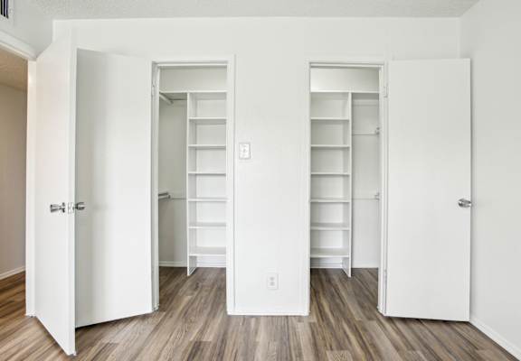 A white door with a silver handle is open.