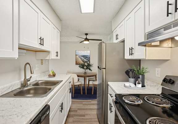 Modern kitchen at Trailgrove Apartments with white shaker cabinets and stainless-steel appliances