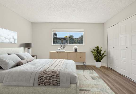 Spacious bedroom at Trailgrove Apartments in Denver with large windows and ample closet space