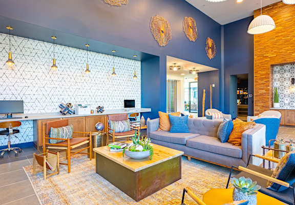 A living room with a blue couch and a wooden coffee table.