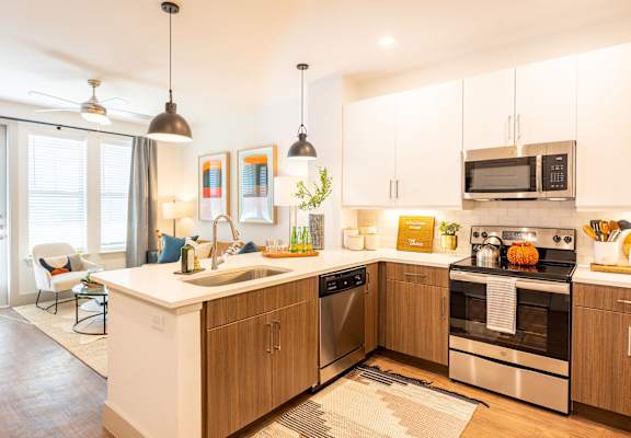 A modern kitchen with wooden cabinets and stainless steel appliances.