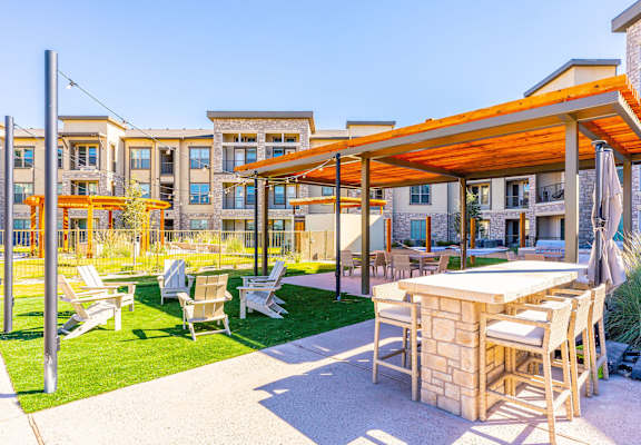 A patio with a table and chairs under a canopy.