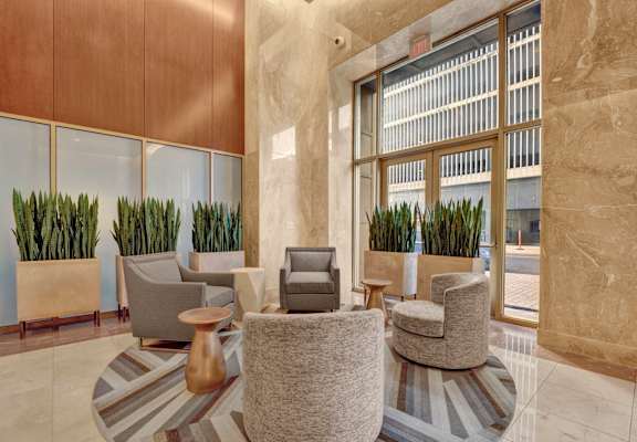 a lobby of a building with chairs and plants at Metro67, Memphis, 38103