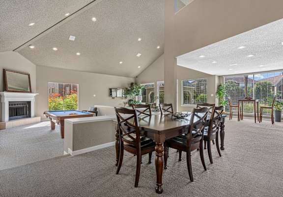 A large dining room with a long table and chairs.