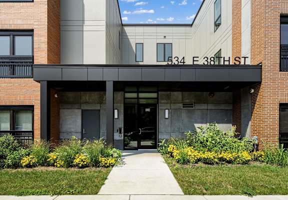 the front of a building with a sidewalk in front of it