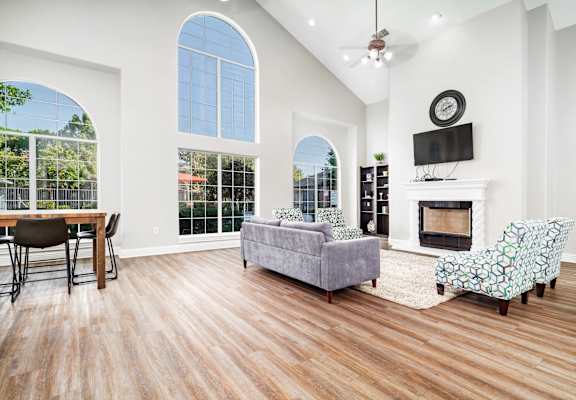 A living room with a fireplace and a television.