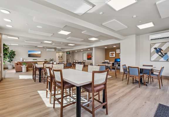 A modern office space with wooden floors and furniture. at The Orion Senior Apartments - Orange, CA Apartments, California, 92866