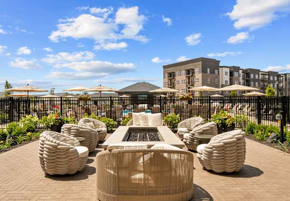 A modern outdoor seating area with a fountain in the middle.