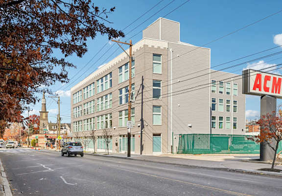 A street view with a building that has the letters ACM on it.