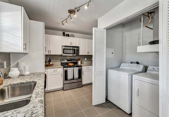 a kitchen with white appliances and granite counter tops at Sunset Ridge, Texas