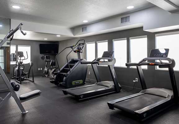 A gym with treadmills, elliptical machines, and other exercise equipment at Verandas Apartments, California, 91791