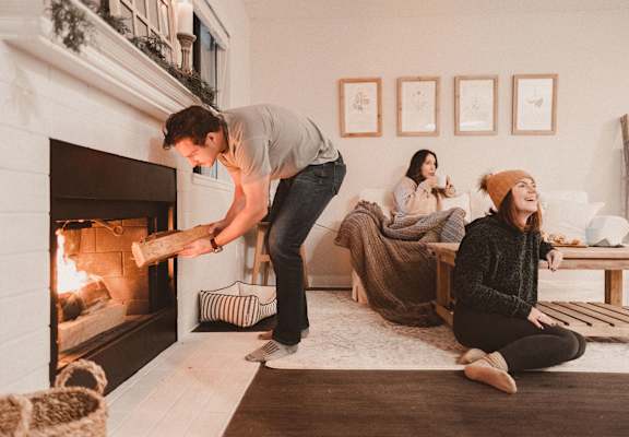 Townhomes with a View Model Living Room and Fireplace with Group of Friends Hanging Out