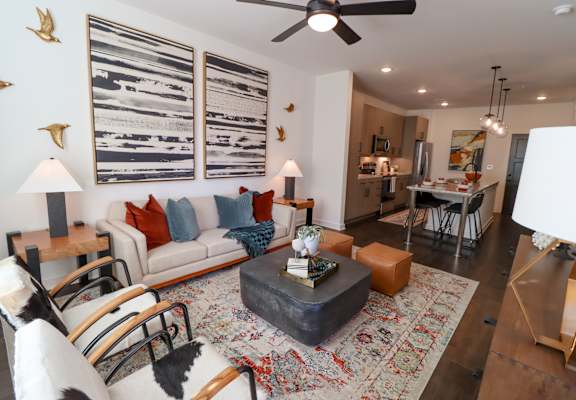A living room with a white couch and a coffee table. at The Wren Apartments, Lawrenceville, 30043
