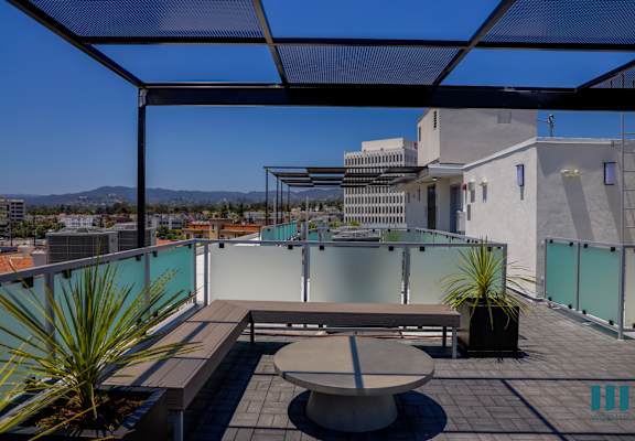 a roof terrace with a table and a view of the city