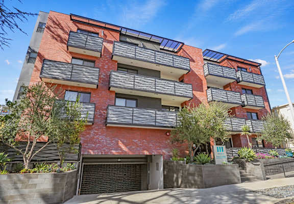 a red brick apartment building with a garage