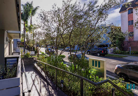 a view of the street from the balcony of a building
