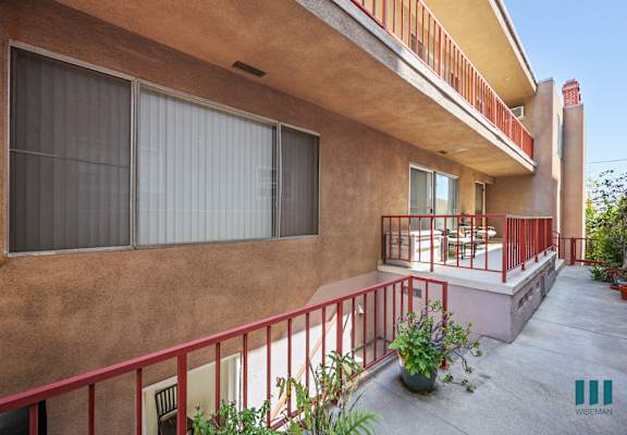 A house with a red railing and a balcony.