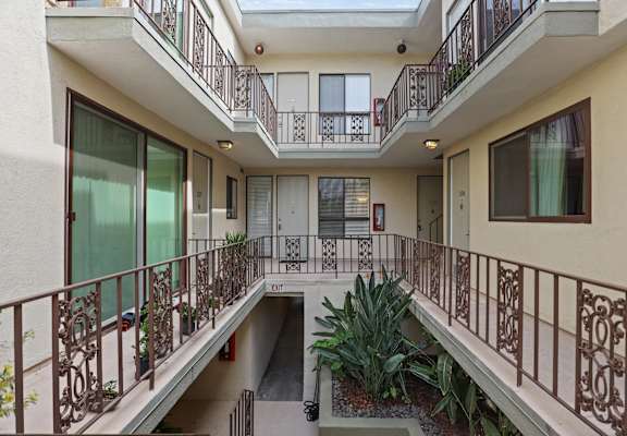 A balcony with a metal railing and a glass door.