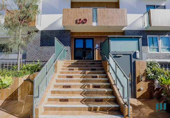 a set of stairs in front of a building with a glass door