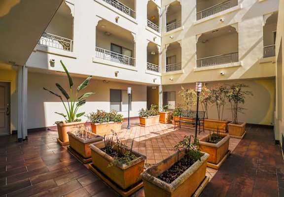 a large lobby with potted plants and benches